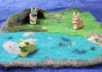 felted playmats with 3 wooden animals and a hidey hole